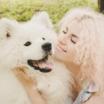 Woman with white, furry dog