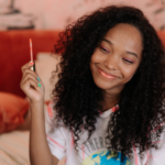 Girl smiling holding glossier product